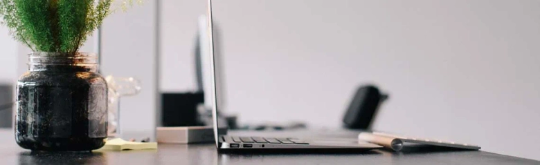 Laptop on an office desk: a personal assistant supports an individual with administrative tasks
